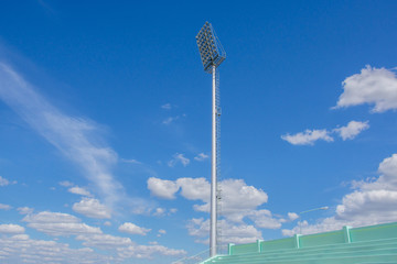 high pole Spotlight Stadium lights with blue sky background.
