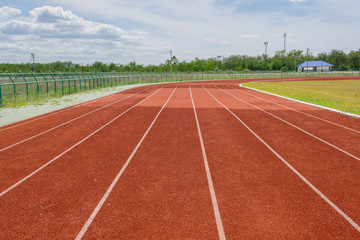 Red Running track with corner of the football field.