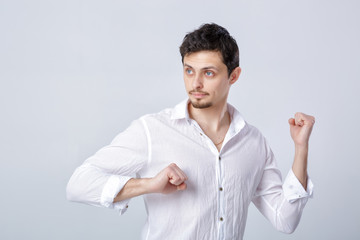 portrait of attractive man with dark hair in white shirt ready f