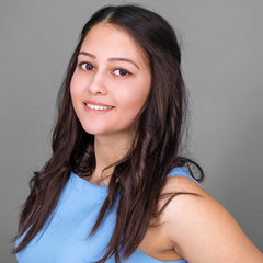Fototapeta premium Young pretty American girl in a blue dress