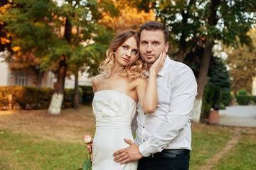 Young romantic man and woman hugging in the park. The concept of marriage and love story.