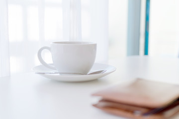 Coffee time in the morning, coffee cup with smartphone and wallets.