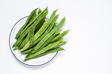 Fresh green beans on a white background