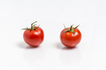 Two tomatoes, isolated on white background