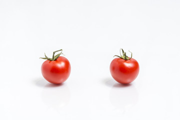 Two tomatoes, isolated on white background