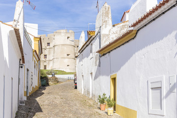 Fototapeta na wymiar a street and the castle in Evoramonte village, municipality of Estremoz, Alentejo, Portugal