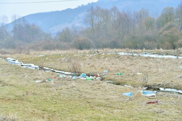 Garbage in nature. Plastic bottles left after water was withdrawn