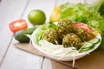 Delicious falafel salad. Salad include tomatoes, cucmbers and falafel.