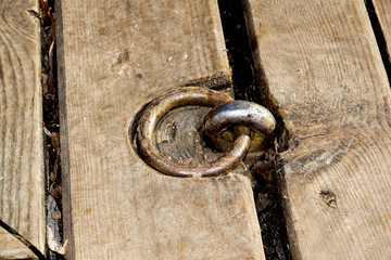 small metal hooks detail on quay for mooring boats, on the wood pier
