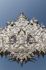 Fototapeta na wymiar Sculpture detail with white Buddha in all-white buddhist temple Wat Rong Khun in Chiang Rai, Thailand, symbol of creativity, serenity and peace