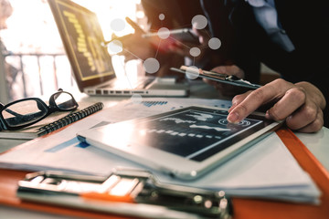 Businessman making presentation with his colleagues and business tablet digital computer at the office as concept in morning light
