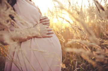pregnant woman relaxing outside in the park