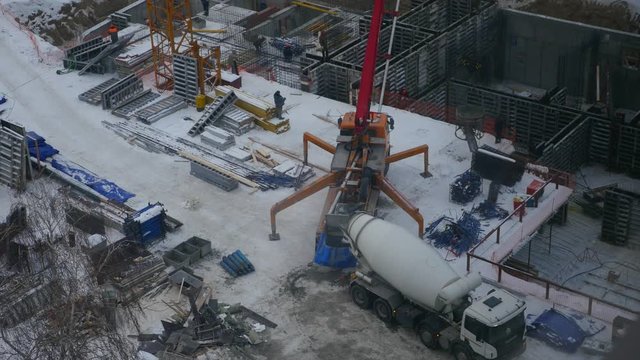 cement mixer at a construction site is worth prevent concrete and pumped it into the foundation. 3840x2160, 4K