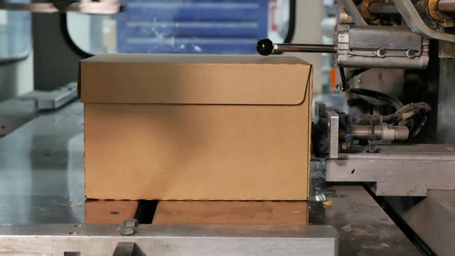 Cardboard Boxes are collected and transported by a robot on the conveyor belt