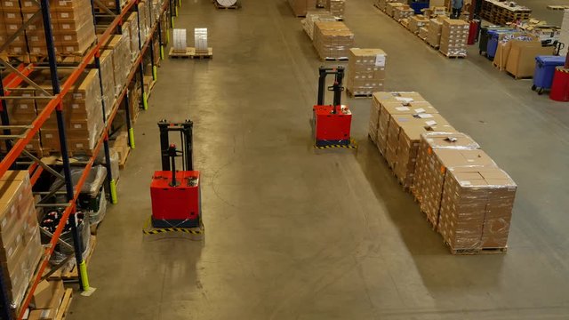 Forked Automatic Guided Vehicles (AGV) pallet truck, unmanned driving through factory hall
