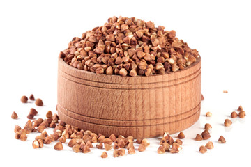 buckwheat in a wooden bowl isolated on white background