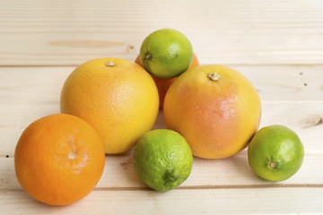 fresh orange ,limes and grapefruits on a wooden background