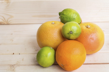 fresh orange ,limes and grapefruits on a wooden background