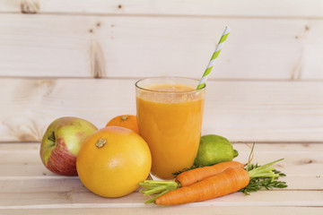orange smoothie with  carrots ,apple,grapefruit,lime and orange . Healthy life concept.