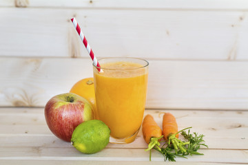 orange smoothie with  carrots ,apple,grapefruit,lime and orange . Healthy life concept.