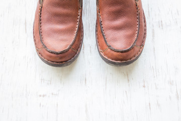 Men's fashion with brown leather shoes with space on white wooden background
