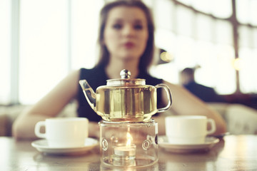 girl drinks tea in a restaurant