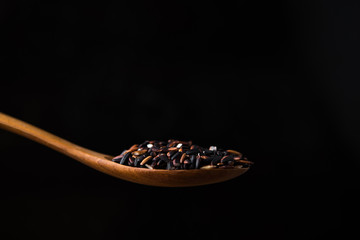 rice berry in wooden spoon