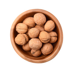 Walnuts in wooden plate isolated on white