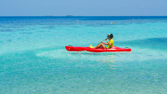 Young caucasian man kayaking in sea at Maldives - Boost up color Processing.