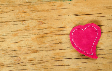 Heart from cloth on wood desk