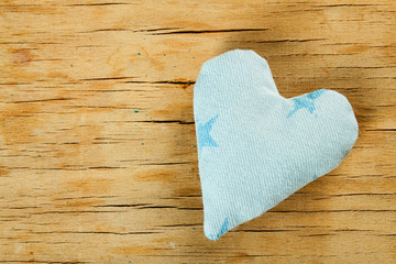 Heart from cloth on wood desk
