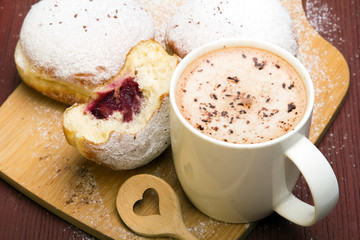Classic donuts with powdered sugar, on wooden background