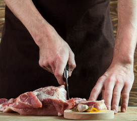 Butcher cutting pork meat