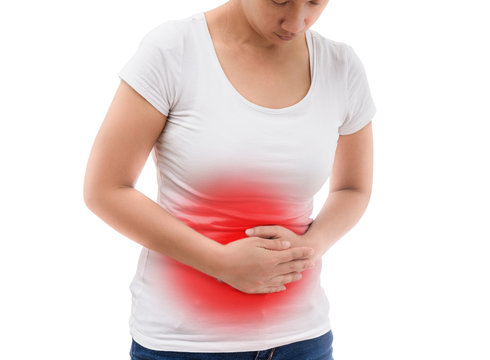 Young casual woman is having stomach ache.