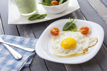 Food fried egg spinach salad wood background
