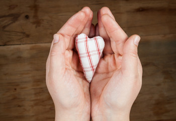 Heart from cloth on wood desk