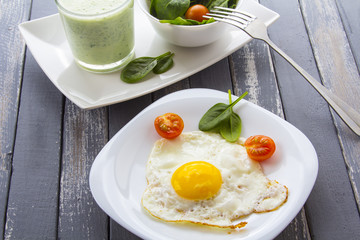 Food fried egg spinach salad wood background
