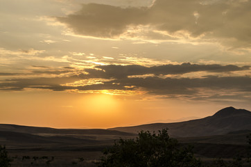 Obraz premium Beautiful evening view of the Azerbaijan mountains green grass meadows and hills at sunset time. Summertime
