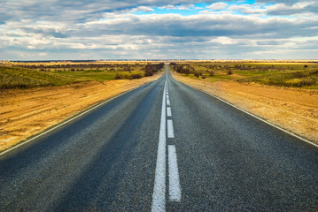 Fototapeta na wymiar Empty straight road in the desert, the highway M6 