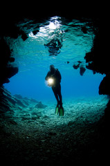 Diver  front  of cave Mediterranean sea    