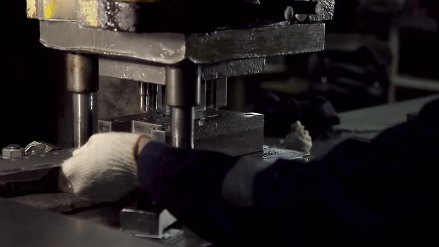Close-up of hands working on the machine