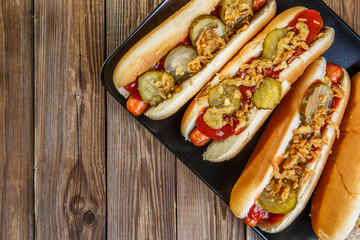 American hot dog with pickles,onions, ketchup and mustard