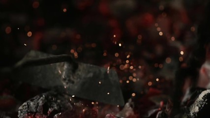 MACRO COALS: iron stick mixes burning coal