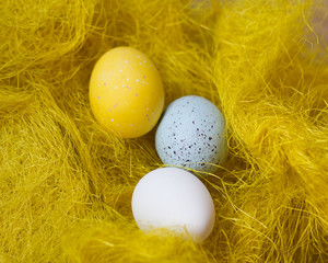 Fototapeta na wymiar Easter, festive colored eggs on the bright yellow background