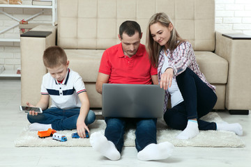 Family having fun chating on internet with laptop. Family having fun chating on internet with...