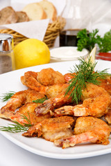 Breaded Shrimp with parsley and dill on a white plate