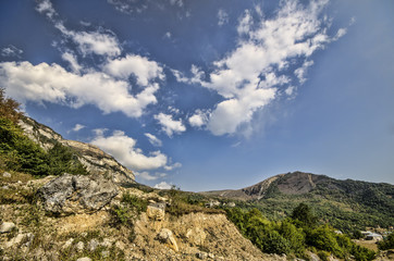 Fototapeta na wymiar Rocky Mountains Landscape with sunny sky with clouds. Beautiful Caucasus nature. Azerbaijan Guba