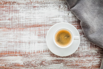 Cup of coffee on a wooden table.