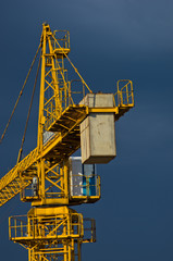 Yellow construction crane against dark blue sky in Belgrade, Serbia