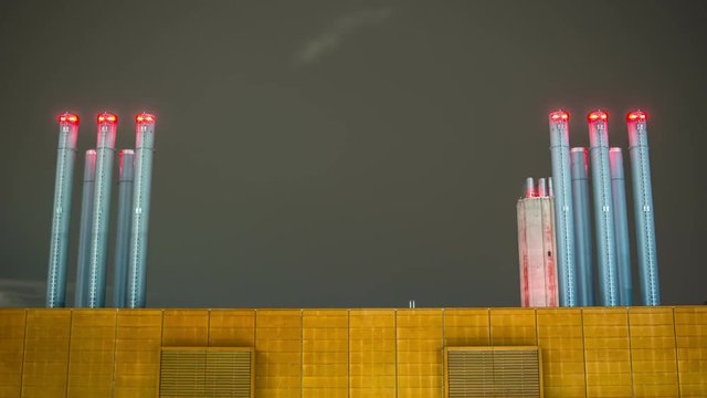 Time Lapse pf chimneys on rooftop at night